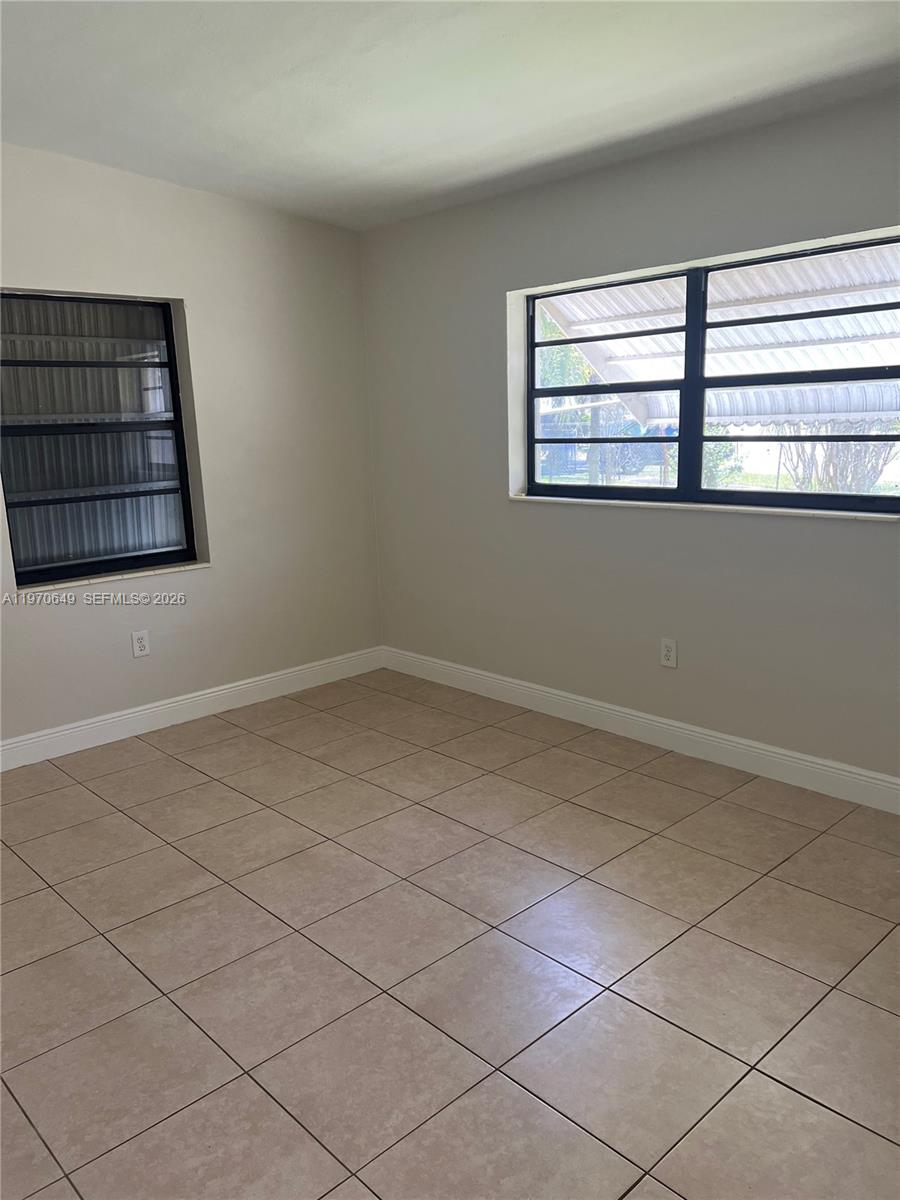 14435 Southwest 289th Street Homestead, FL 33033 - Photo 9 of 18 a view of empty room with window