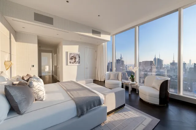 a bedroom with a bed and a couch