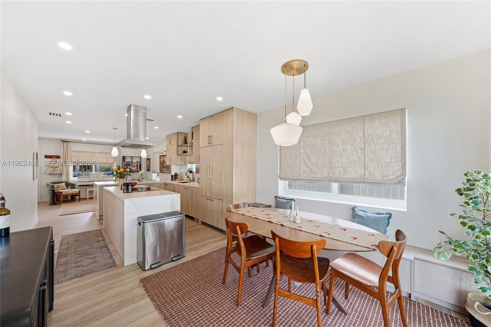 1737 Southwest 11th Street Miami, FL 33135 - Photo 3 of 30 a kitchen with stainless steel appliances granite countertop a kitchen island hardwood floor sink stove dining table and chairs