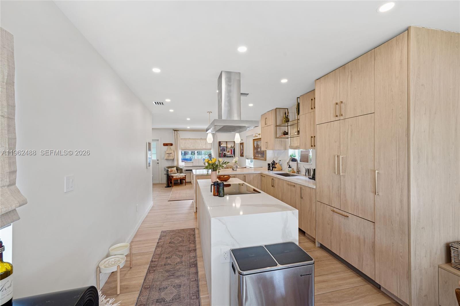 1737 Southwest 11th Street Miami, FL 33135 - Photo 5 of 30 a view of a kitchen with kitchen island stainless steel appliances refrigerator stove microwave and cabinets