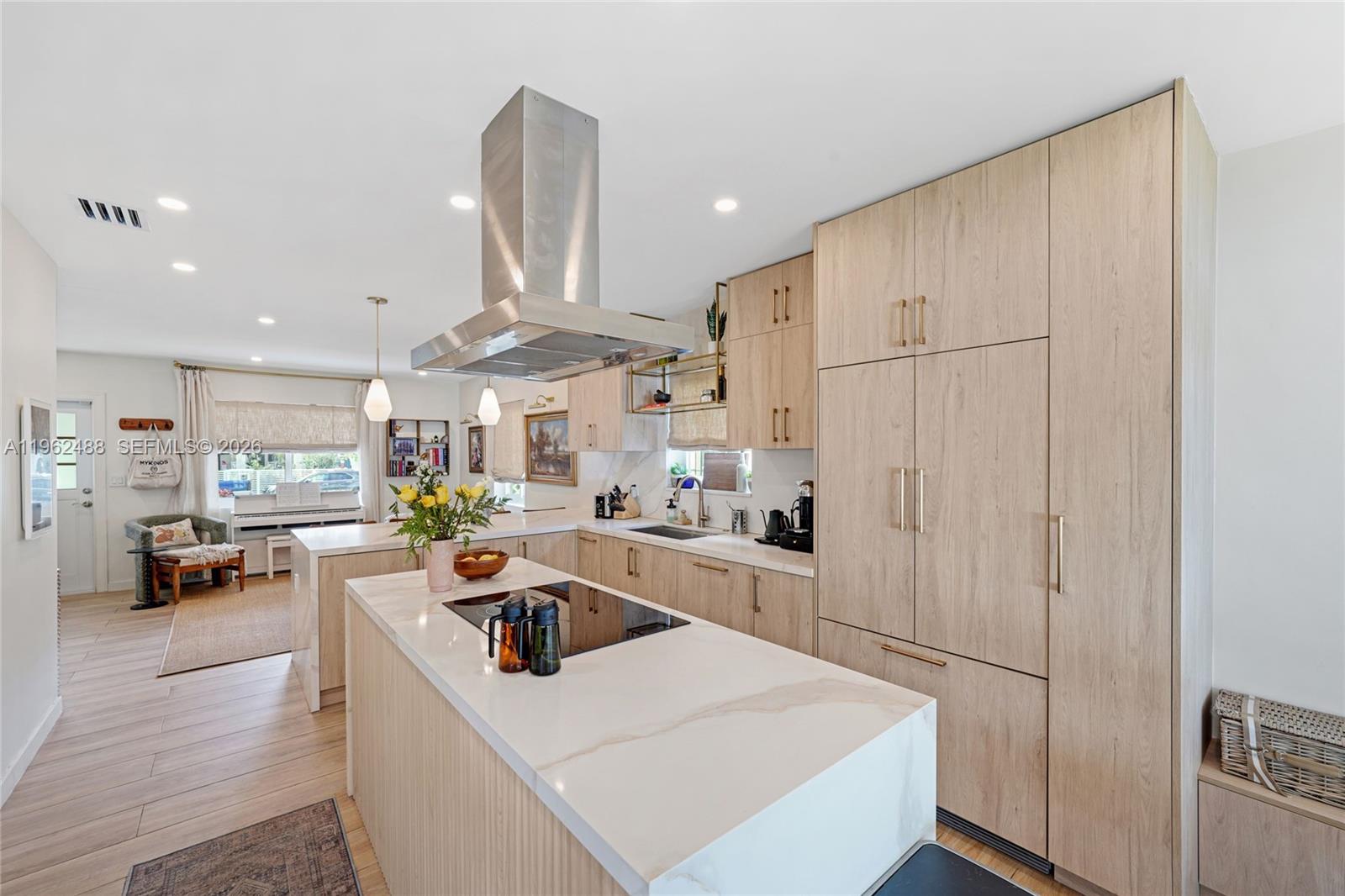 1737 Southwest 11th Street Miami, FL 33135 - Photo 7 of 30 a kitchen that has a lot of white cabinets and stainless steel appliances