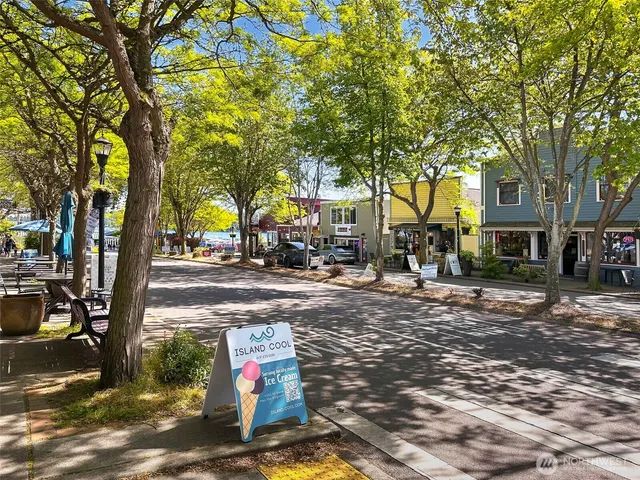a front view of a house with swimming pool and outdoor seating