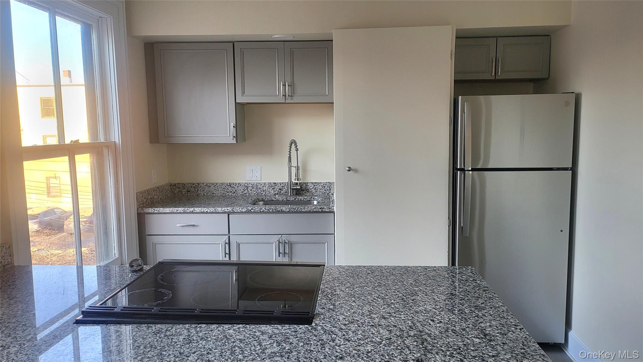 216 Church Street, Unit 2 Poughkeepsie, NY 12601 - Photo 2 of 13 Kitchen with refrigerator, gray cabinetry, and electric stove top