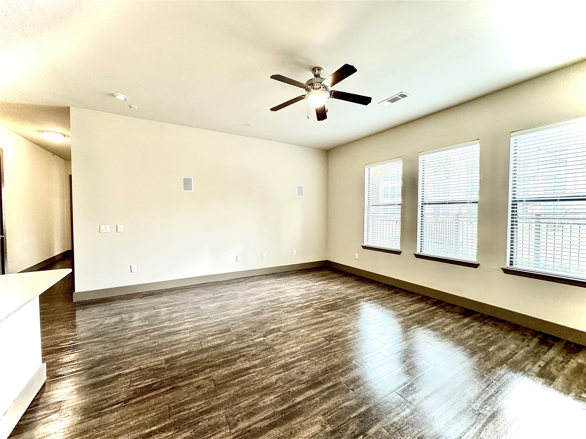 2033 South Gessner Road, Unit 2108 Houston, TX 77063 - Photo 2 of 21 a view of an empty room with window and wooden floor