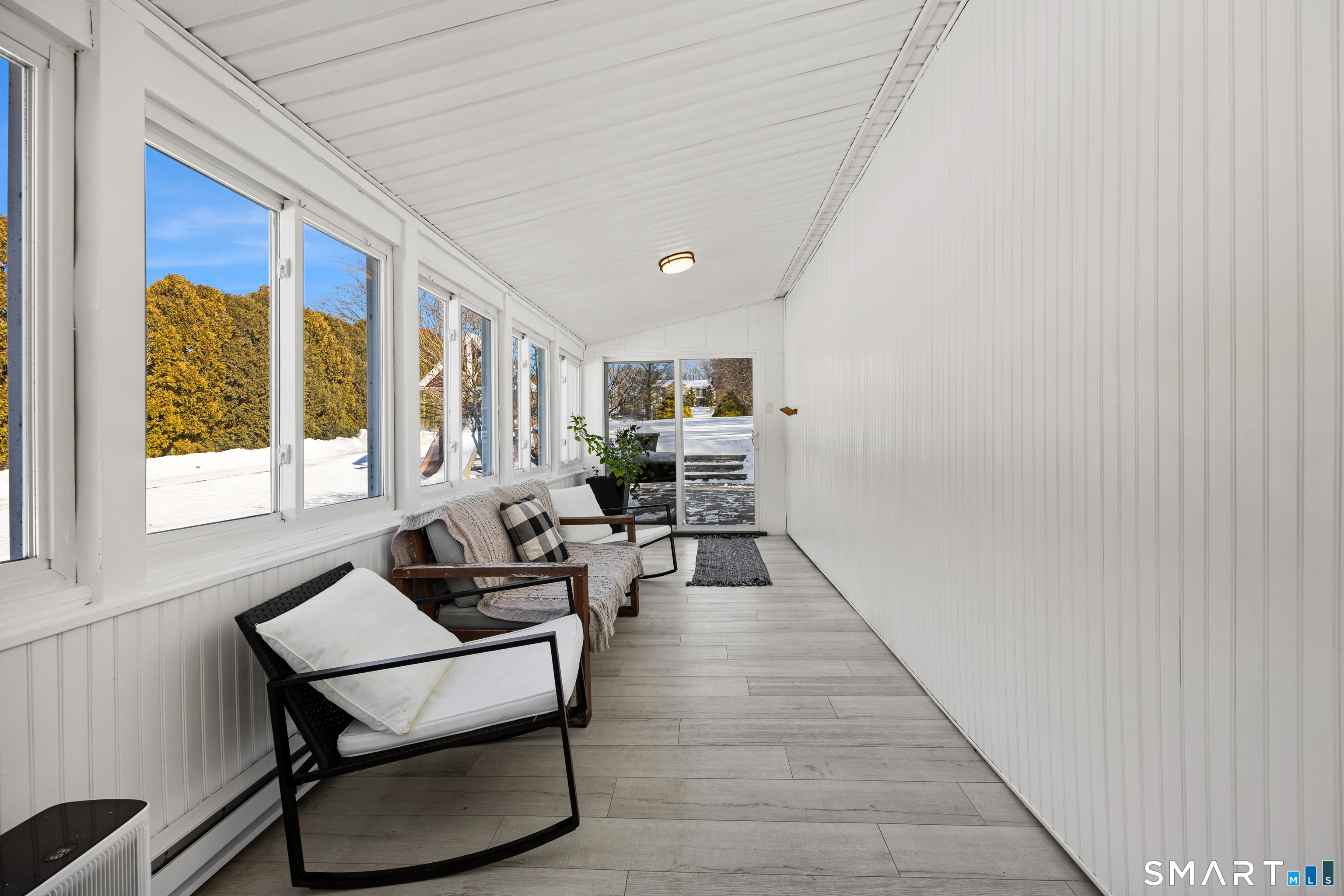 237 Warner Road East Haven, CT 06473 - Photo 21 of 40 4 season sunroom that allows you to walk out to the side and back yards separately.