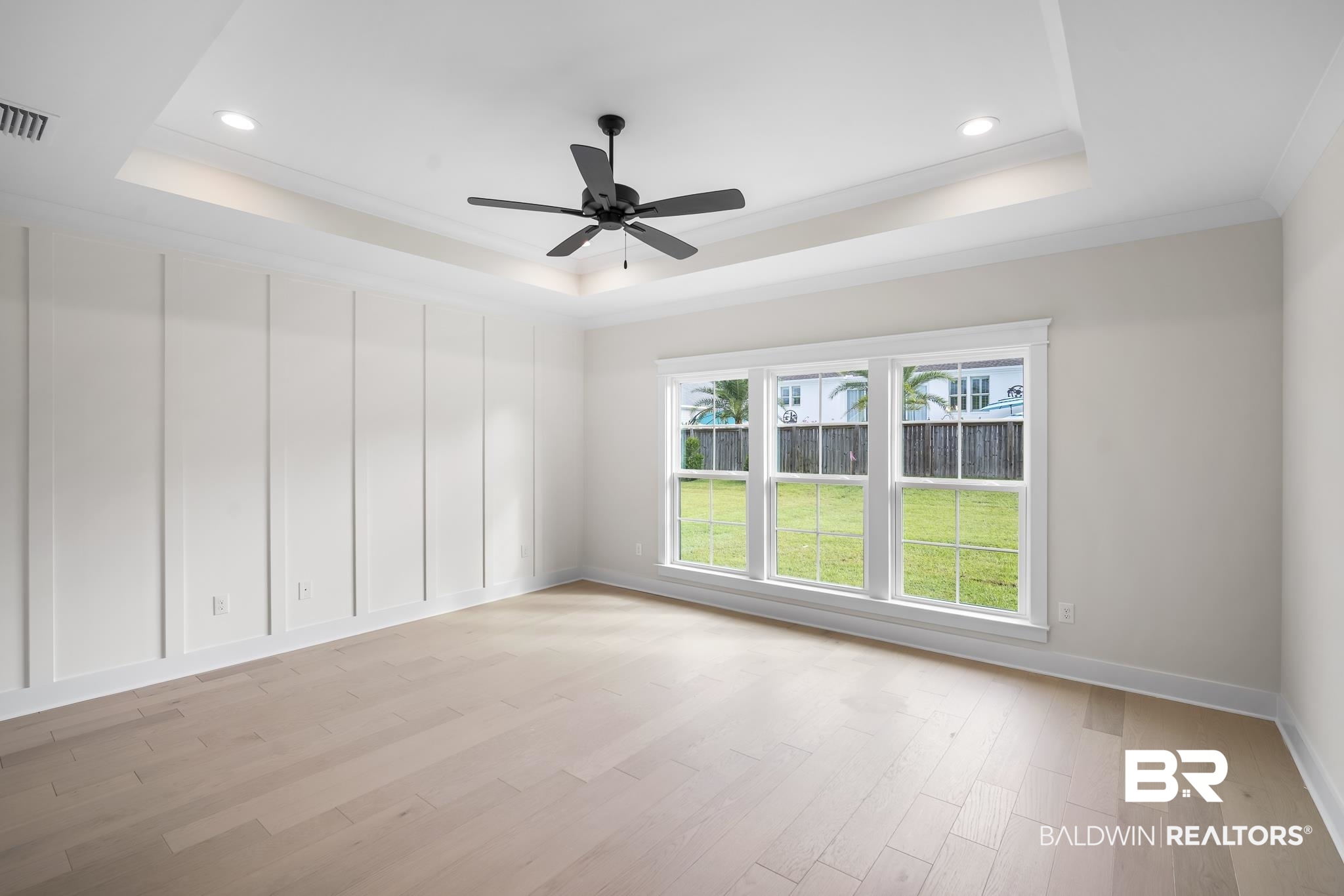 21826 Veranda Boulevard Fairhope, AL 36532 - Photo 15 of 42 bedroom featuring a tray ceiling, light wood-type flooring, ceiling fan, recessed lighting, and crown molding