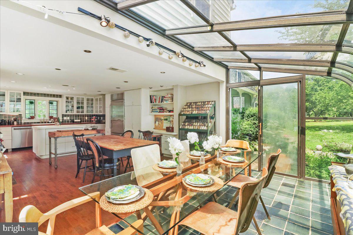 920 Cherry Valley Road Princeton, NJ 08540 - Photo 15 of 58 a dining room with furniture a chandelier and wooden floor
