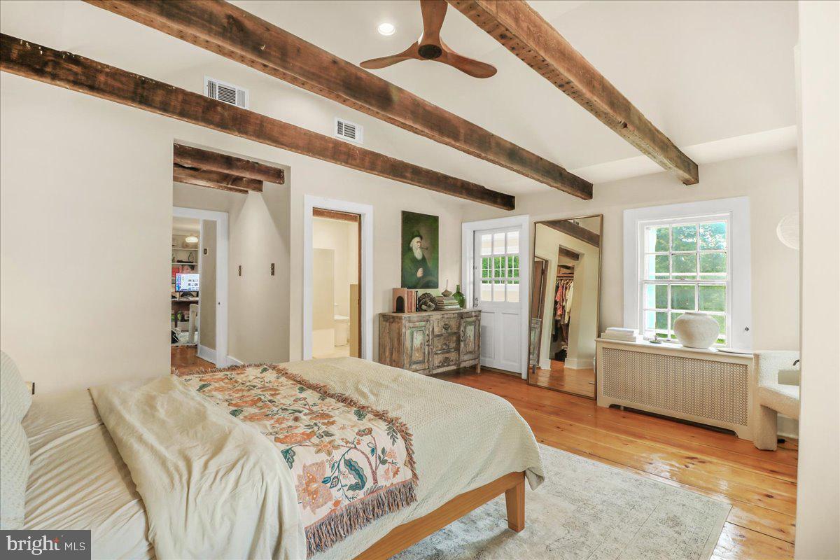 920 Cherry Valley Road Princeton, NJ 08540 - Photo 30 of 58 a spacious bedroom with a large bed and wooden floor