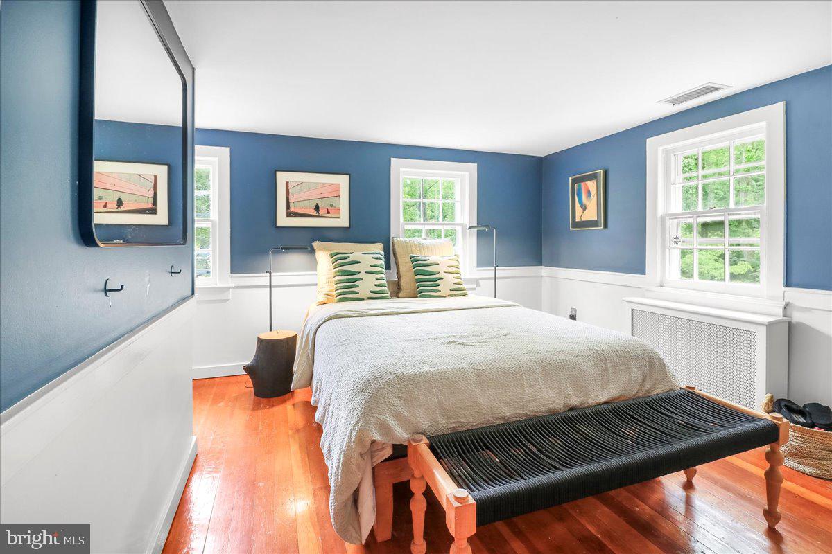 920 Cherry Valley Road Princeton, NJ 08540 - Photo 40 of 58 a bedroom with a bed and wooden floor