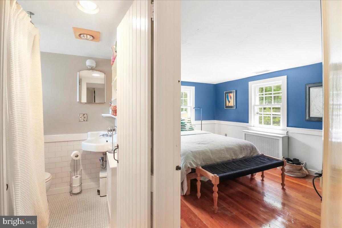 920 Cherry Valley Road Princeton, NJ 08540 - Photo 41 of 58 a bedroom with a bed and wooden floor