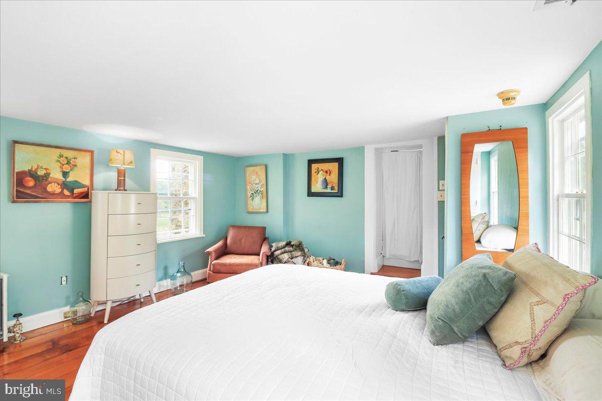 920 Cherry Valley Road Princeton, NJ 08540 - Photo 46 of 58 a bedroom with a bed and wooden floor