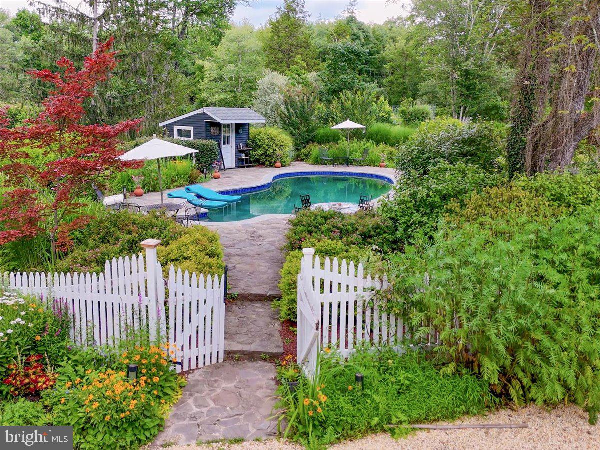 920 Cherry Valley Road Princeton, NJ 08540 - Photo 9 of 58 a front view of a house with a garden
