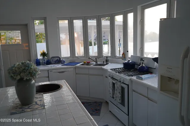 a kitchen with a sink stove and cabinets