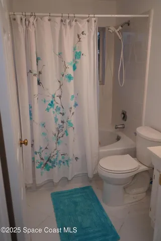 a bathroom with a shower and a toilet