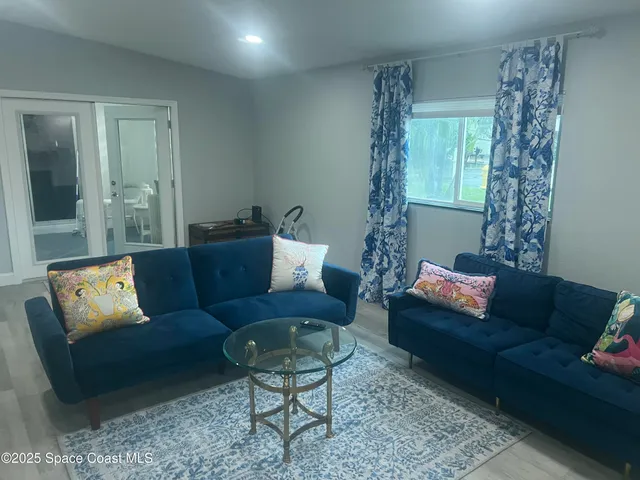 a living room with furniture and a potted plant