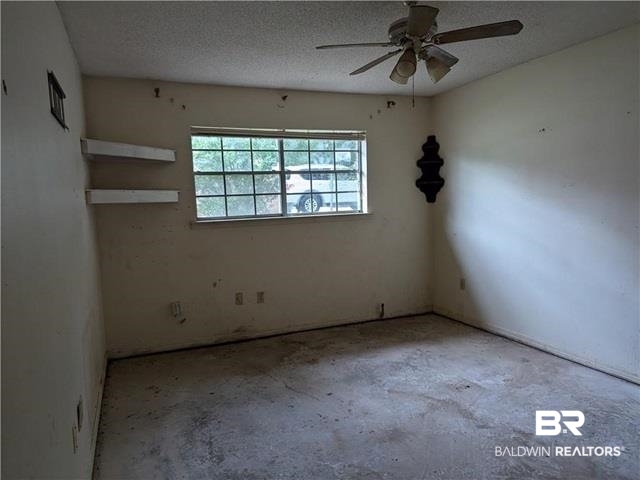3817 Lansdowne Circle Mobile, AL 36693 - Photo 9 of 16 Unfurnished room featuring ceiling fan and a textured ceiling