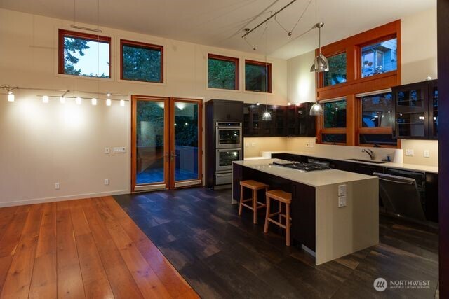630 Harrison Street Friday Harbor, WA 98250 - Photo 17 of 37 a kitchen with stainless steel appliances granite countertop a stove and a wooden floors