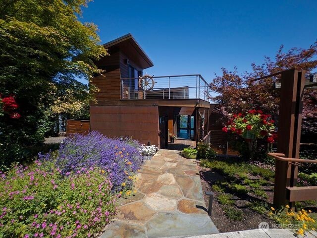 630 Harrison Street Friday Harbor, WA 98250 - Photo 6 of 37 a front view of a house with a yard and mountain view in back