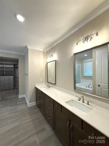 a bathroom with a double vanity sink and a mirror