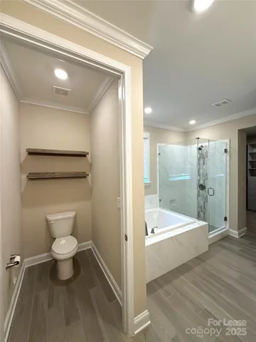 a bathroom with a toilet sink and shower