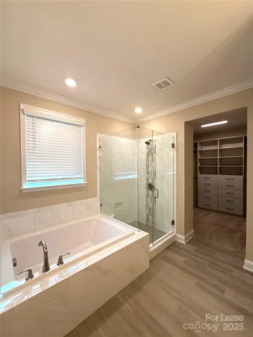 a spacious bathroom with a bathtub and a shower