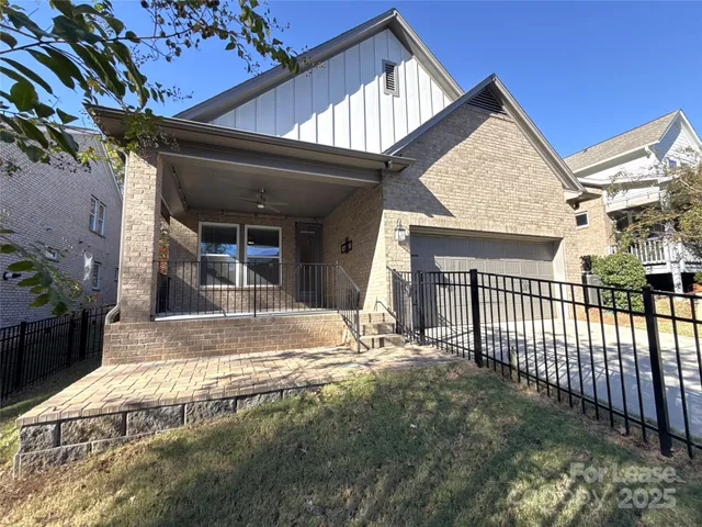 a view of a house with a small yard and floor to ceiling window