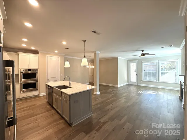 a kitchen with stainless steel appliances granite countertop a stove and a refrigerator
