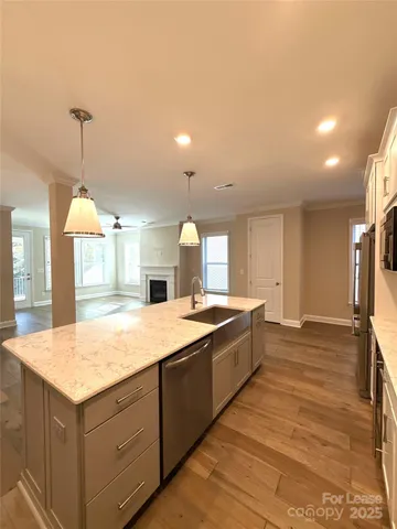 a large kitchen with kitchen island a sink stainless steel appliances and cabinets