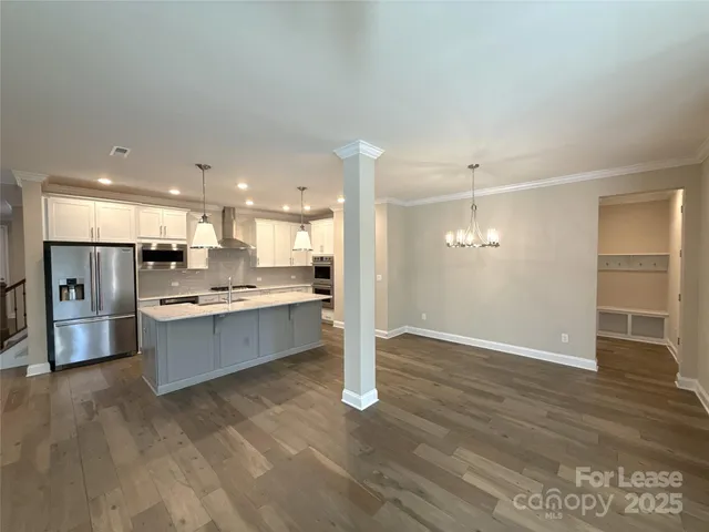 a large kitchen with a lot of counter space and stainless steel appliances