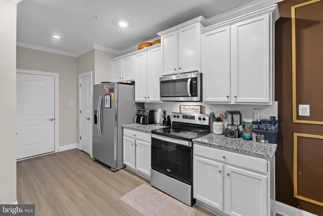 a kitchen with stainless steel appliances a refrigerator stove and sink