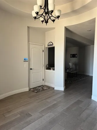 a view of a chandelier fan and wooden floor