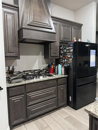a kitchen with stainless steel appliances granite countertop a stove and a refrigerator