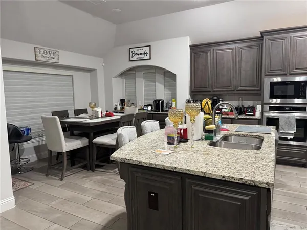 a kitchen with granite countertop a sink and a stove