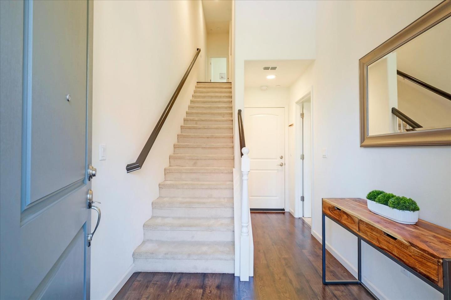 39846 Sawyer Terrace Newark, CA 94560 - Photo 5 of 21 a hallway with wooden floor stairs and wooden floor