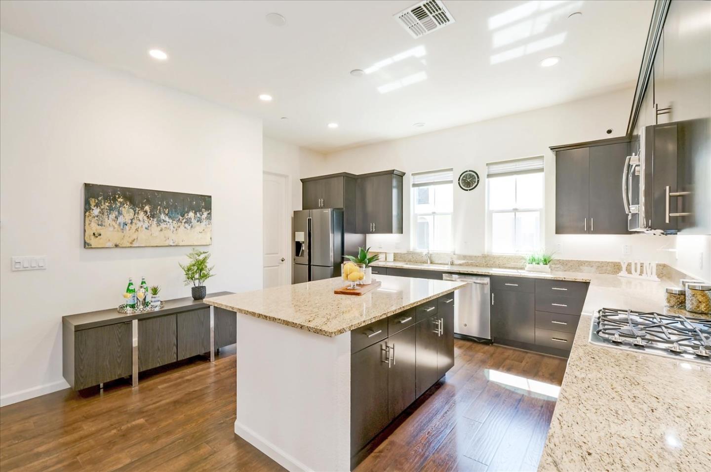 39846 Sawyer Terrace Newark, CA 94560 - Photo 7 of 21 a kitchen with stainless steel appliances granite countertop a sink stove and refrigerator