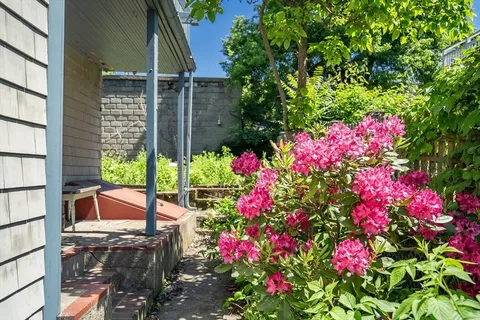 a view of flower garden in front of house