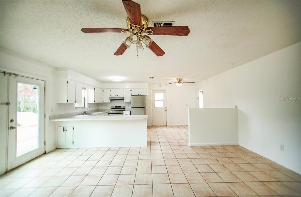 606 Water Road Ocala, FL 34472 - Photo 6 of 34 a open kitchen with white cabinets and white appliances