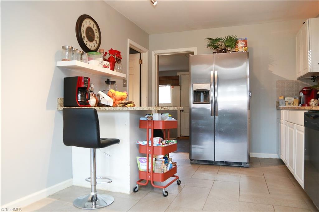 2012 Armhurst Road Greensboro, NC 27405 - Photo 8 of 23 Kitchen with granite and stainless steel appliances