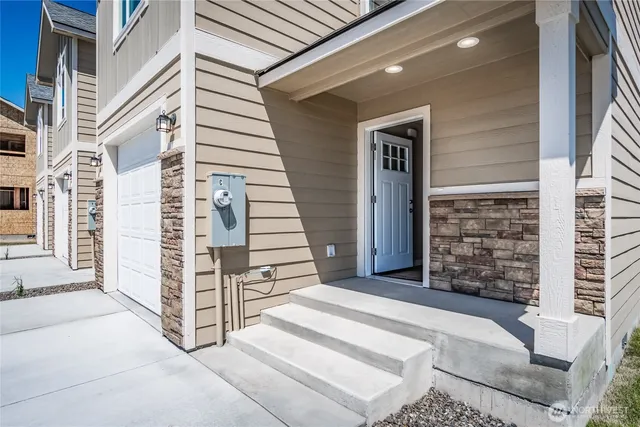 a view of a hallway with wooden floor and entryway