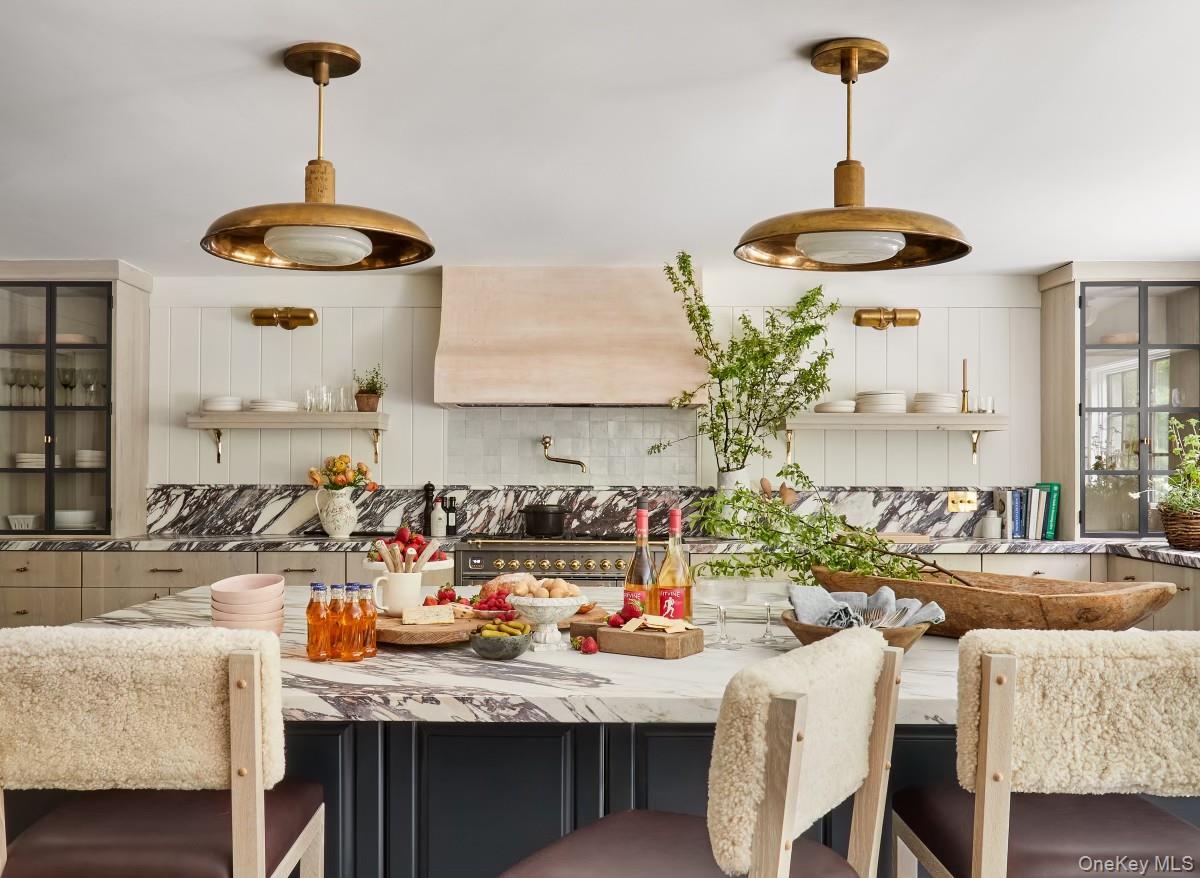 240 Eastwoods Road Pound Ridge, NY 10576 - Photo 12 of 13 a kitchen with a table and chairs in it
