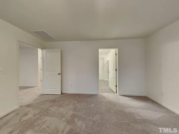 a view of an empty room and a window