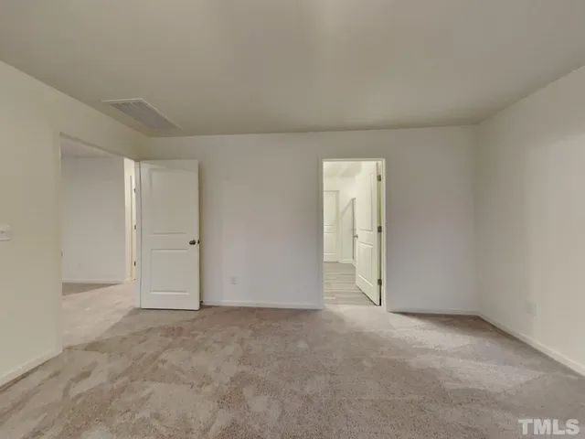 a view of an empty room and a window