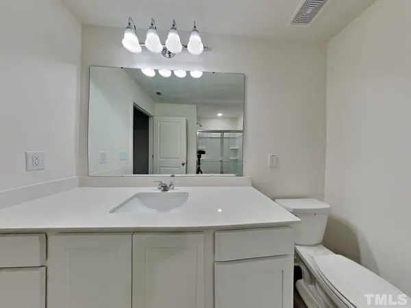 a view of kitchen with a sink wooden floor and chandelier