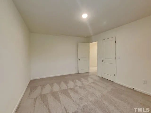 a view of empty room with a ceiling fan and window