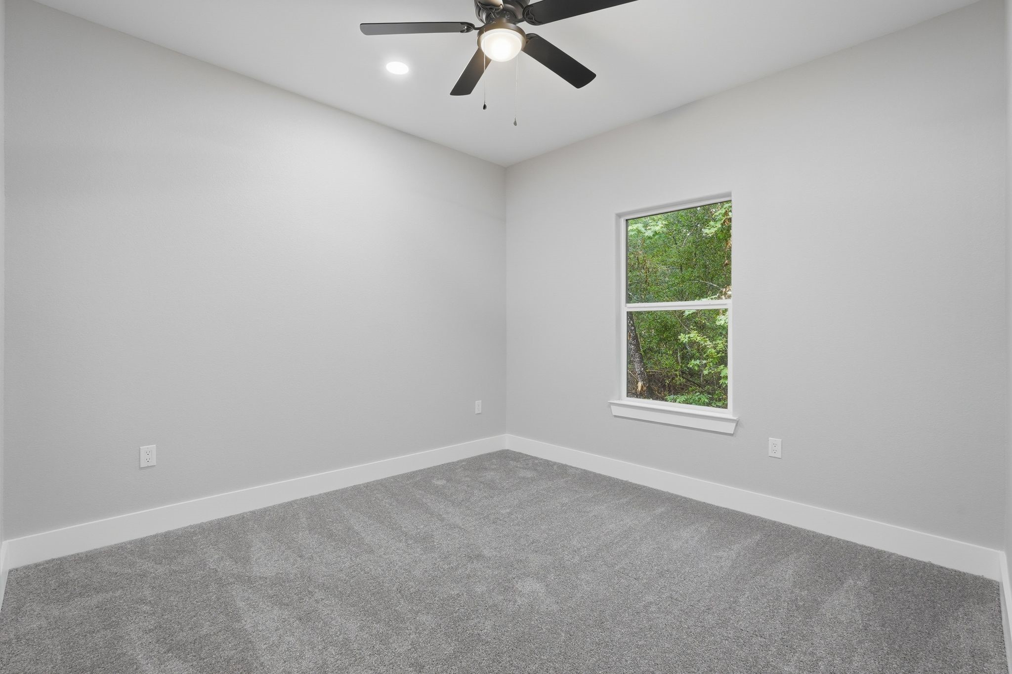 3575 Roy Bean Road Willis, TX 77378 - Photo 29 of 40 an empty room with a window and a ceiling fan