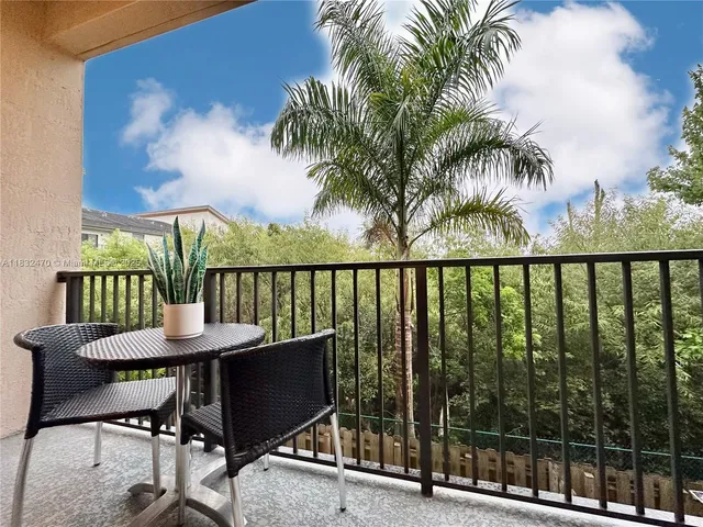 a view of a chairs and table in patio