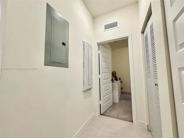 a view of a hallway with a livingroom and a bathroom