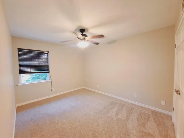 a view of a big room with chandelier fan