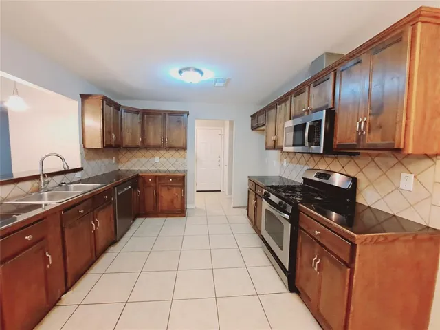 a spacious bathroom with a granite countertop sink and a mirror