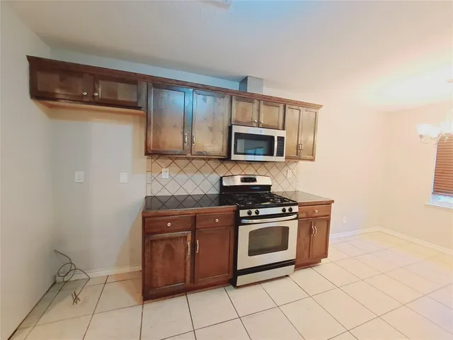 a view of a livingroom with an empty space and a window